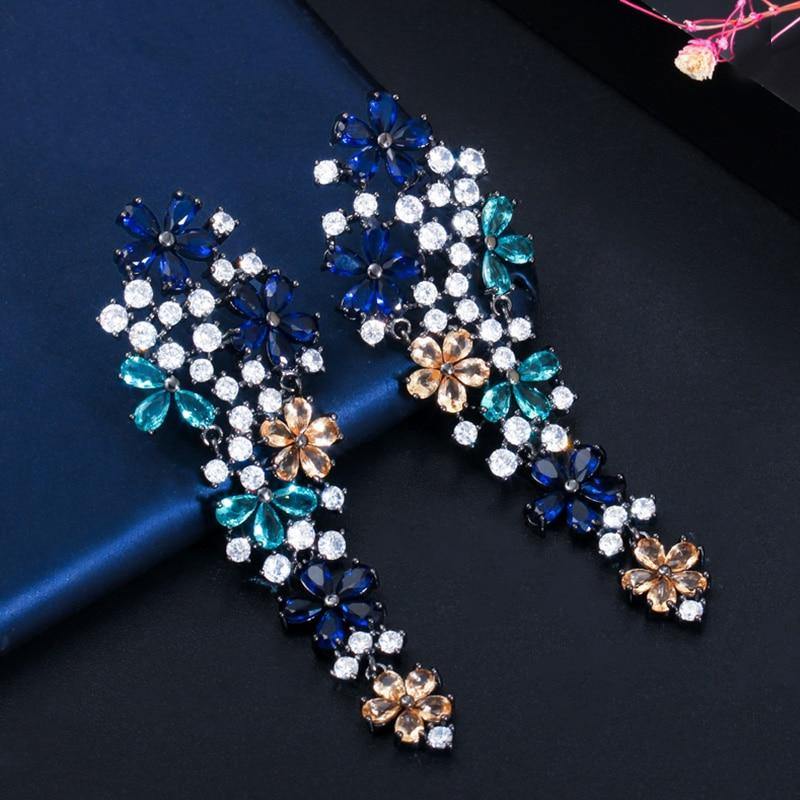 Dazzling Flower AAA+ CZ Paved Black Gold Long Drop Champagne Blue Earrings - The Jewellery Supermarket